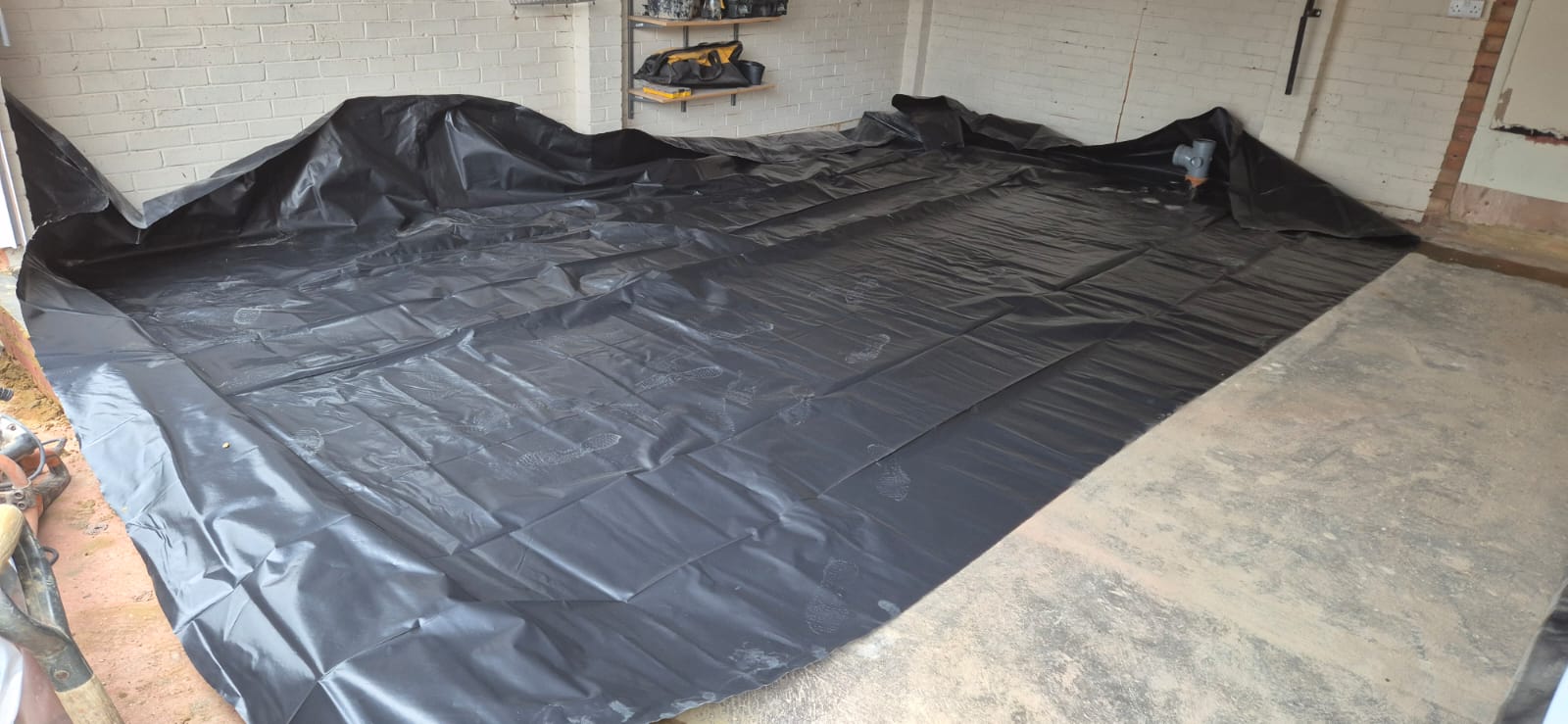 Damp-proof membrane laid across the double garage floor during conversion in Chelmsford